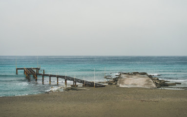 Empty sandy coast at Mediterranean sea in winter after storm in Alanya, Turkey