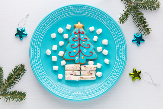 Homemade Christmas tree cookie, marshmallow and nougat on a plat