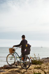 Fototapeta premium Defocused silhouette of child and father with bike on a beach natural outdoor. Travel vacation background