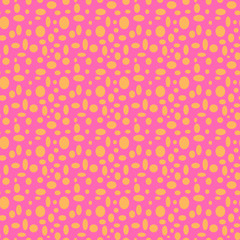 Seamless pink pattern with orange polka dots in different sizes as a background - Eps10 vector graphics and illustration