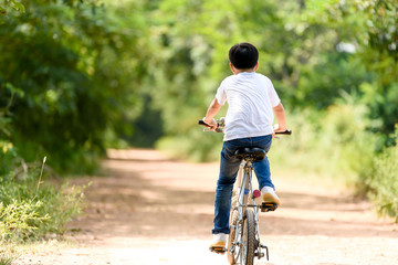 Fototapeta na wymiar Young boy ride bicycle