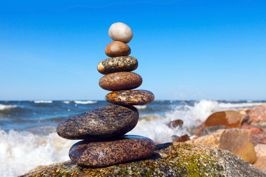 pyramid of wet stones on a background of the storm sea