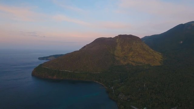 Aerial view coastline on tropical island with sea, trees and palms. Aerial footage.Aerial video from flying drone of amazingly beautiful landscape of nature with mountains,hills, rain forest. Seascape
