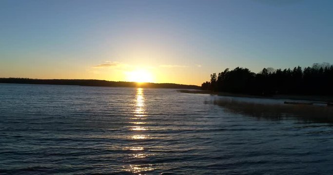 Cinema 4k aerial flight towards a sunset in the finnish archipelago of Inkoo, in Finland