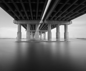 Black and white photo of bridge and river