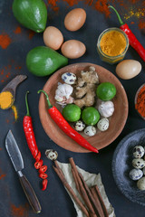 Top view of healthy spices and food ingredients on the black background