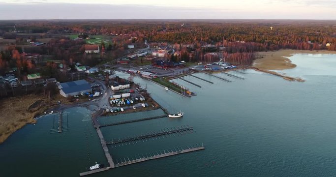 Cinema 4k flight away from Inkoo town, at a sunset, on a evening, in the finnish archipelago, in Finland