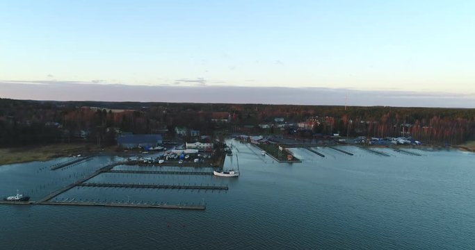 Cinema 4k rising aerial view of Inkoo town, at a late evening sunset, on a autumn day, in the finnish archipelago, in Finland