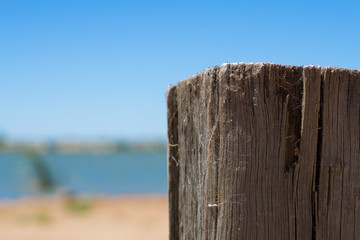 Weathered wooden post at waters edge - 133356351