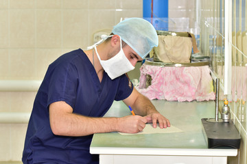Nurse/The doctor writes a report about the nuances of the done operation