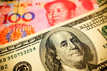 Chinese Yuan Note and U.S. dollar background  (Exchange rate concept)