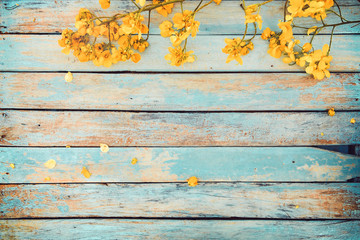 Yellow flowers on vintage wooden background, border design. vintage color tone - concept flower of...