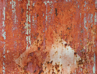Old rusty metal plate with cracked paint.