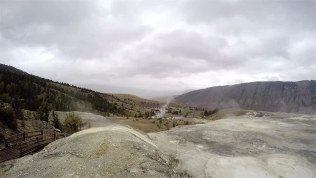 Timelapse of a smoking geysers and north entrance, filmed from the top of mammoth hot springs, in Yellowstone national park, in Wyoming, United states of america