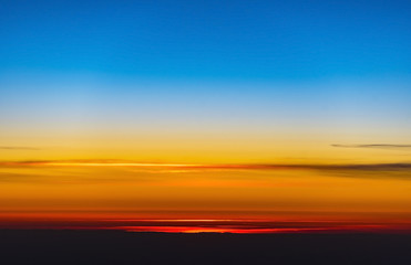 Naklejka na ściany i meble An amazing sunset over earth through a window of a plane, background