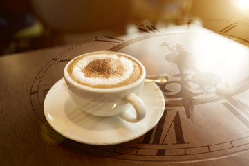 Double exposure of coffee cup with clock face