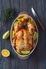 Fried whole chicken with potatoes and lemons