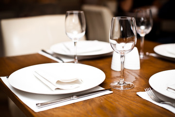 Empty wine glasses on a served table in a fancy restaurant
