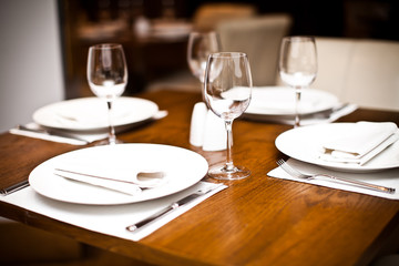 Empty wine glasses on a served table in a fancy restaurant