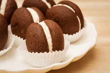 macaroon small round chocolate cake lies in a plate