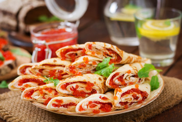 Pancakes with red caviar on plate. Russian cuisine. Maslenitsa