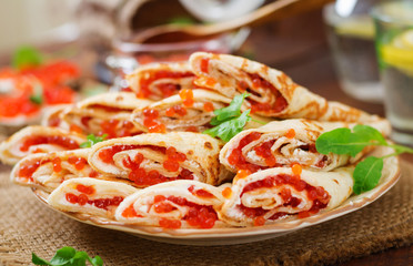 Pancakes with red caviar on plate. Russian cuisine. Maslenitsa