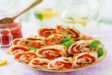 Pancakes with red caviar on plate. Russian cuisine. Maslenitsa