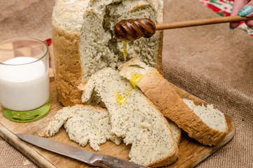 Obraz na płótnie Canvas Bread and honey, milk, rustic wood background.