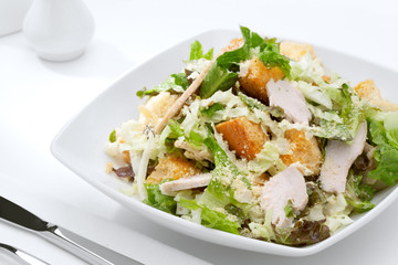 close up view of fresh vegetable salad on white background