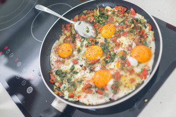 In the course of making breakfast with fresh eggs and vegetables
