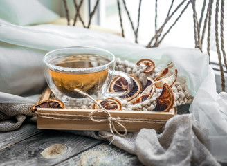 still life with transparent Cup of tea on wooden background