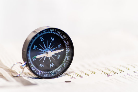 Compass on newspaper