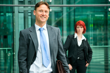 Business People In Front Of An Office Building