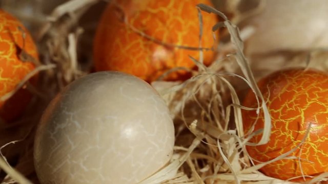 Easter concept. Easter eggs in a straw nest on a wooden background