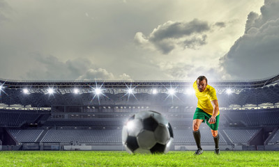 Soccer player at sport arena . Mixed media