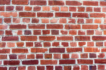 Red bricks in layers as a cladding of a wall