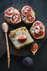 Bruschetta with fig fruits, cottage cheese and honey, above view