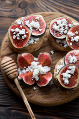 Close-up of figs and cottage cheese bruschettas, studio shot