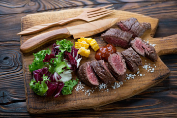 Sliced medium rare grilled machete beefsteak with vegetables