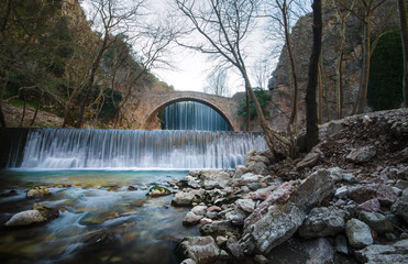 Fototapeta na wymiar Paleokarya, old, stone, arched bridge, between two waterfalls. Trikala prefecture, Thessaly, Greece