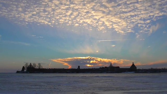 Ancient fortress in the rays of the sun and running clouds. Time lapse of the historic castle Oreshek on island of lake Ladoga in Leningrad region of St. Petersburg. Mystical panorama ancient farpost.