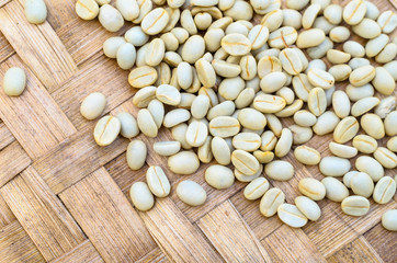raw, unroasted coffee beans drying in sunlight