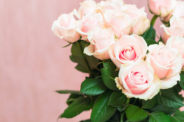 Bouquet of beautiful natural pink roses close up on a soft pink pastel background. Valentines Day romantic concept. Copy space