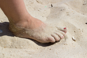 female foot on sand