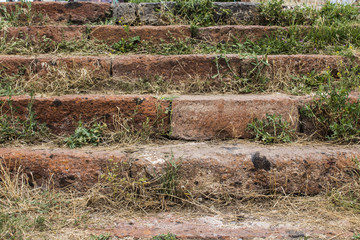 Red Stone stairs covered in grass 