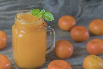 Freshly squeezed healthy citrus tangerine juice in jar and ripe