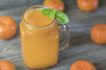 Freshly squeezed healthy citrus tangerine juice in jar and ripe