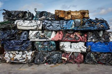 Cars in junkyard,  pressed and packed for recycling.