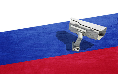 CCTV camera on background of Russian flag