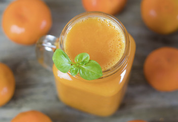 Freshly squeezed healthy citrus tangerine juice in jar and ripe